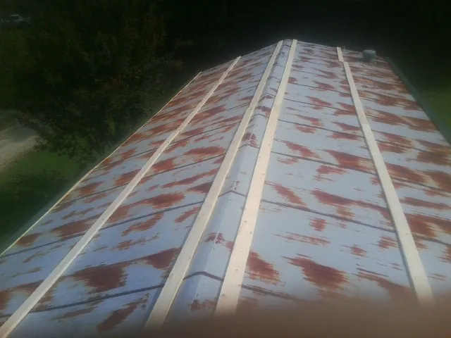 Rusted metal roof panels with new wood purlins before replacement — Storm Damage Roof Repair in Woodinville by Roofing Brothers